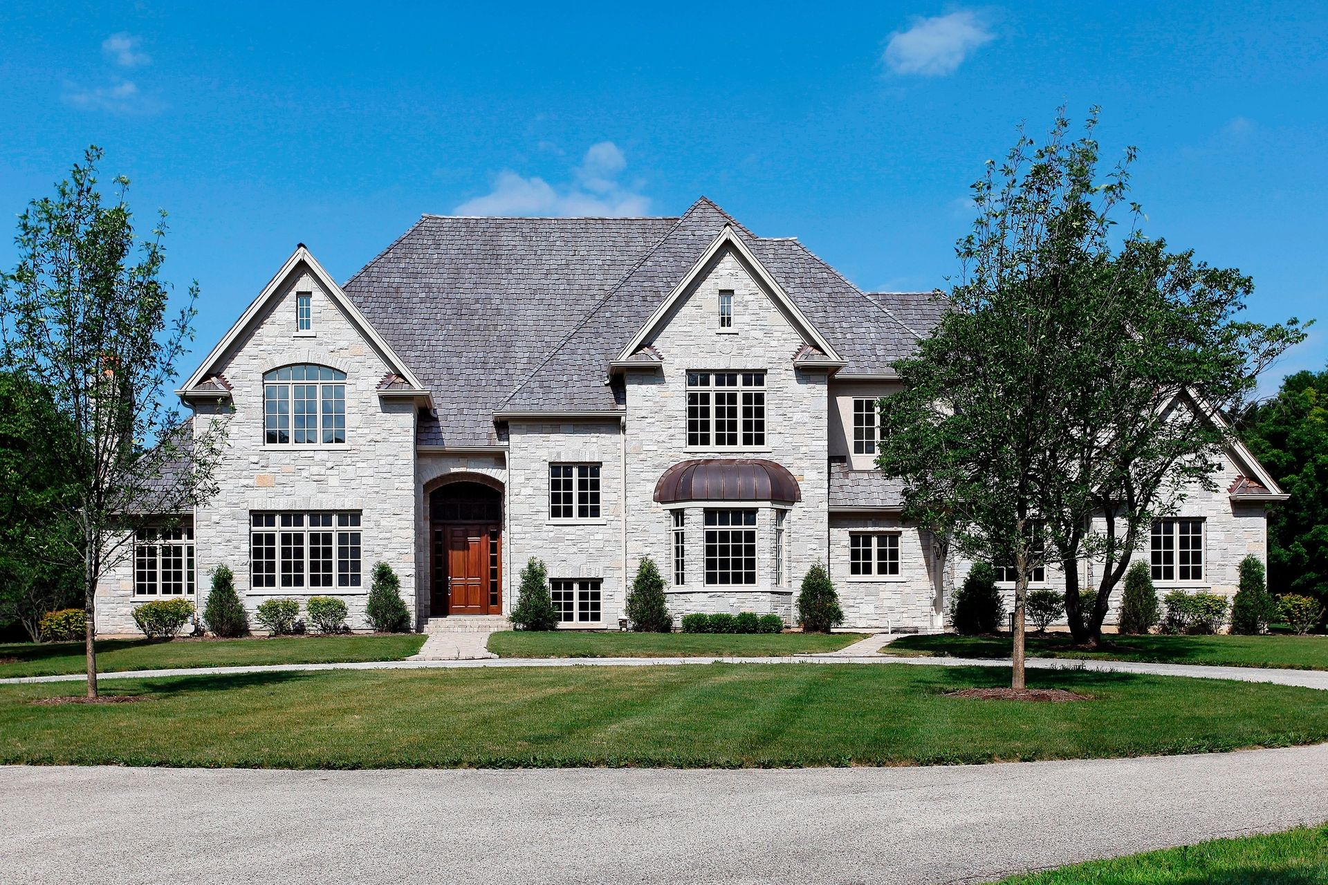 Large white and gray home with cedar roof